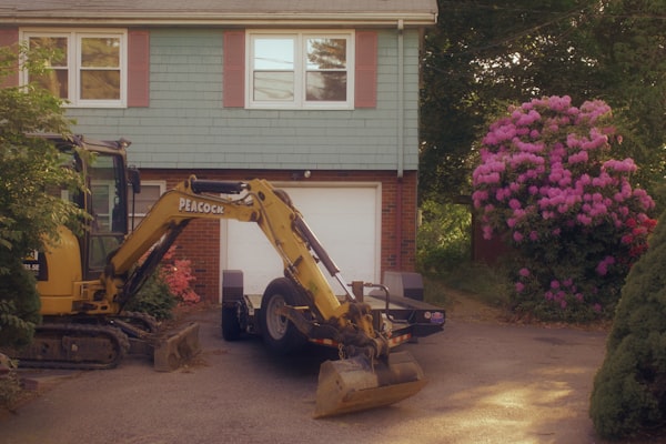 Residential drainage contractor working near a home in Austin